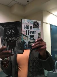 One of our awesome coworkers holding both Six of Crows by Leigh Bardugo and How It Went Down by Kekla Magoon (technically 2014, but still awesome)